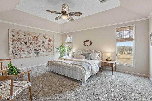 carpeted bedroom featuring ceiling fan, lofted ceiling, and a tray ceiling