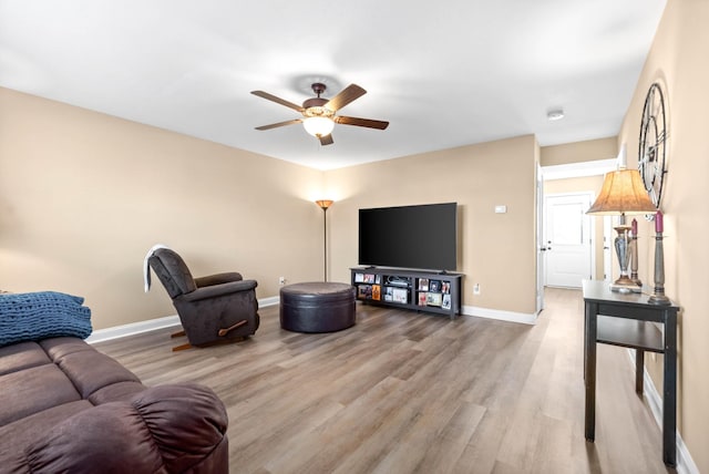 living room featuring hardwood / wood-style flooring and ceiling fan