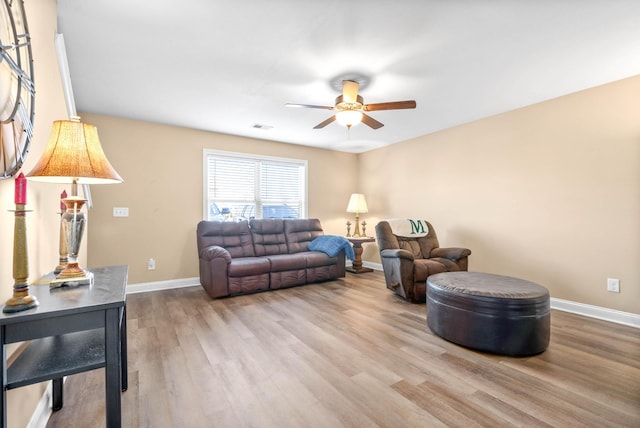 living room with ceiling fan and light wood-type flooring