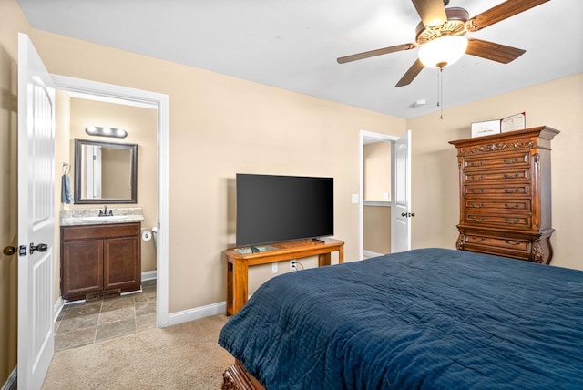 bedroom featuring light carpet, sink, connected bathroom, and ceiling fan