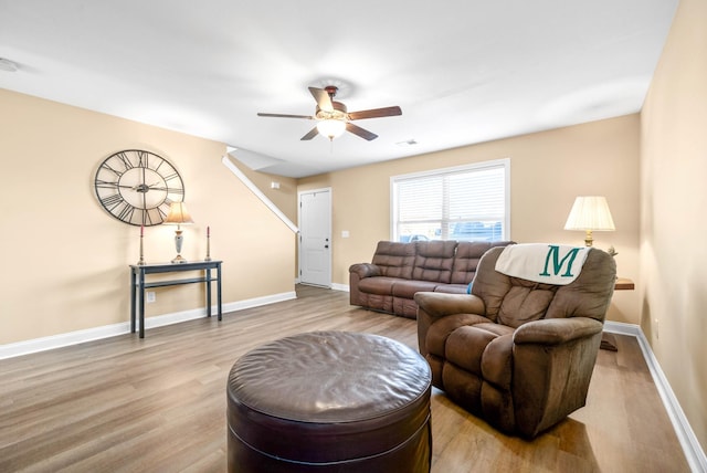 living room featuring ceiling fan and light wood-type flooring