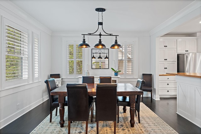 dining space featuring crown molding, plenty of natural light, and dark hardwood / wood-style flooring