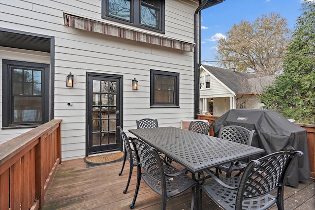 wooden terrace featuring a grill