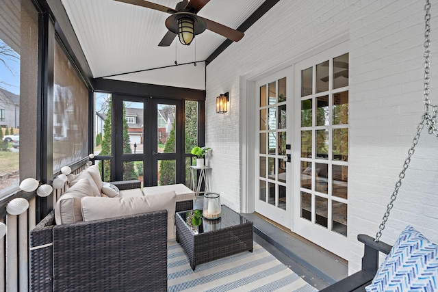 sunroom featuring ceiling fan and lofted ceiling