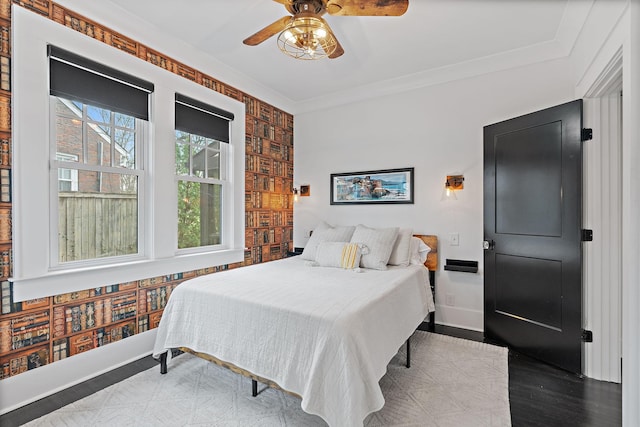 bedroom with ornamental molding, light hardwood / wood-style floors, and ceiling fan