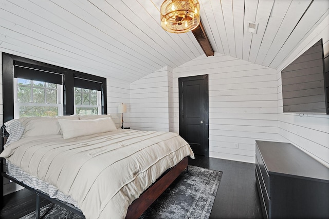 bedroom featuring dark hardwood / wood-style flooring, wooden walls, and lofted ceiling with beams