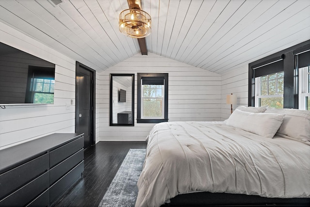 bedroom featuring multiple windows, wooden walls, and dark hardwood / wood-style floors