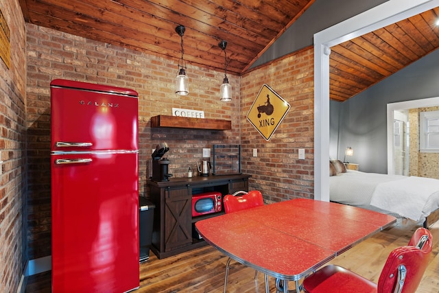 dining space featuring vaulted ceiling, wooden ceiling, wood-type flooring, and brick wall