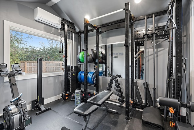 exercise room with vaulted ceiling and a wall mounted AC