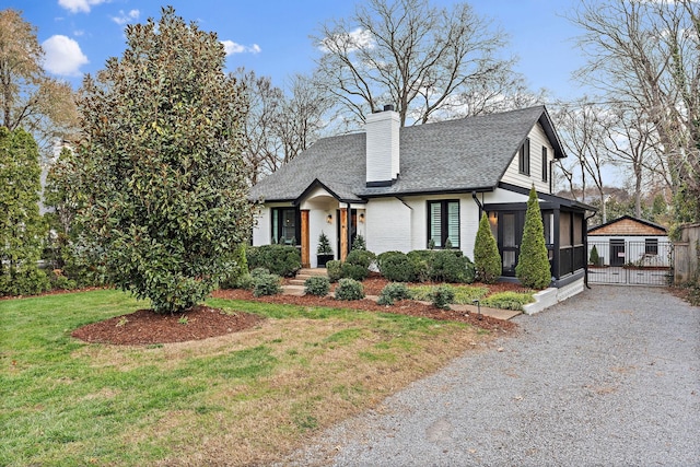 view of front of home with a sunroom and a front yard