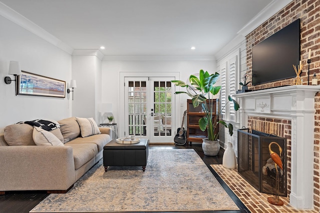 living room featuring a brick fireplace, dark wood-type flooring, ornamental molding, and french doors