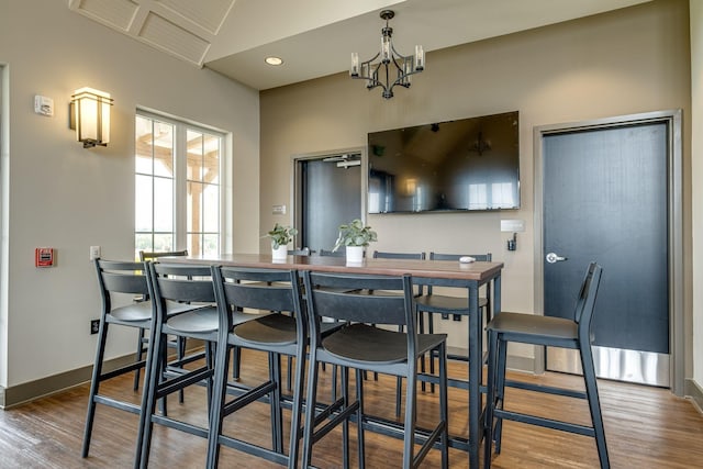 dining room featuring hardwood / wood-style floors and a notable chandelier