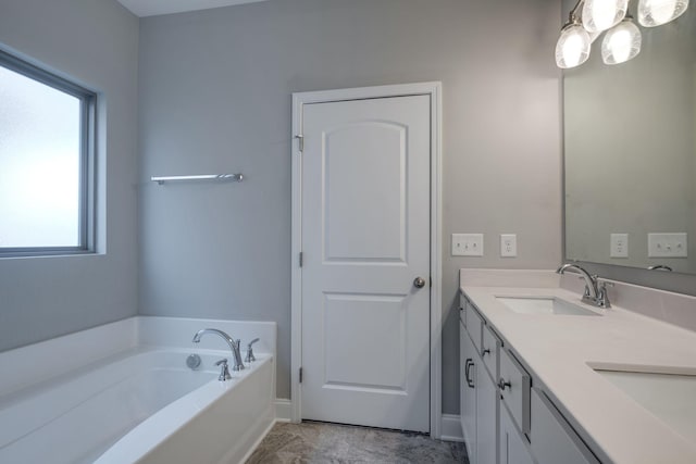 bathroom with vanity, a wealth of natural light, and a bathtub