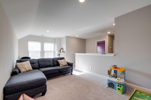 carpeted living room with vaulted ceiling