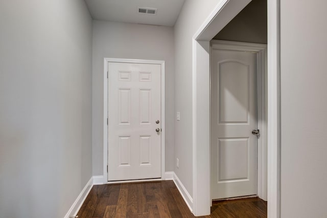 corridor with dark hardwood / wood-style flooring