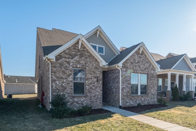 craftsman-style home with a front yard