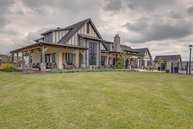 rear view of property featuring a patio area and a lawn