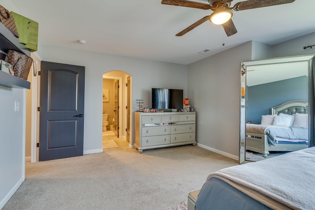 bedroom with light carpet, ceiling fan, and ensuite bathroom