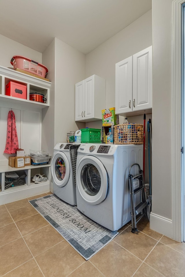 washroom with light tile patterned floors, cabinets, and independent washer and dryer