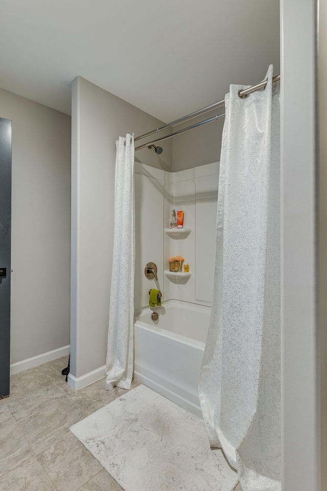 bathroom with shower / bath combo and tile patterned floors