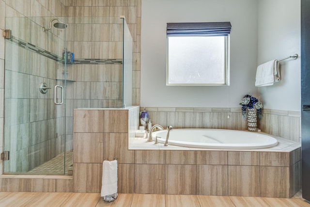 bathroom with shower with separate bathtub