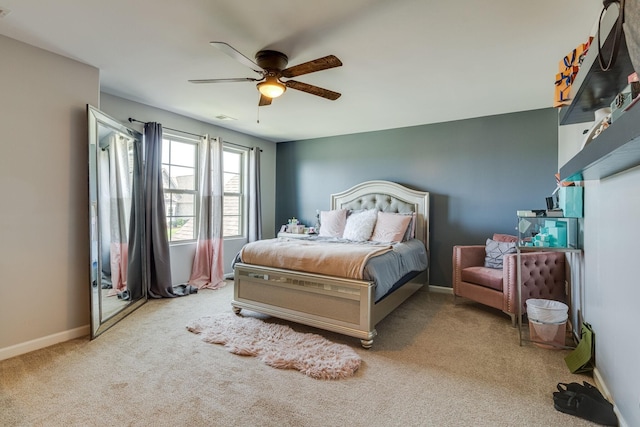 bedroom with ceiling fan and light colored carpet