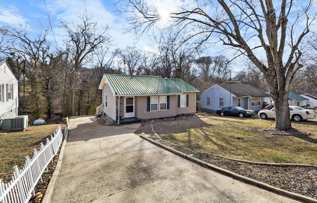 view of front of property with a front yard and central air condition unit