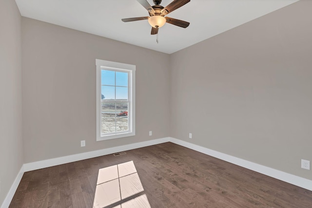 empty room with dark wood-type flooring and ceiling fan