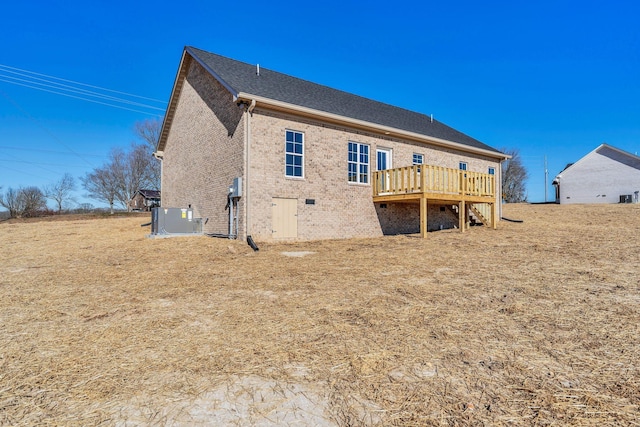 rear view of property featuring central AC unit and a deck