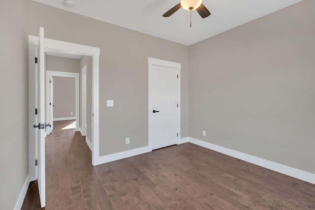 unfurnished bedroom with dark hardwood / wood-style floors and ceiling fan