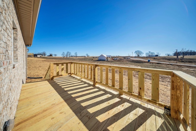 wooden deck with a rural view