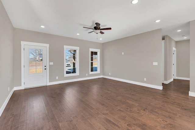 unfurnished living room featuring dark hardwood / wood-style flooring and ceiling fan