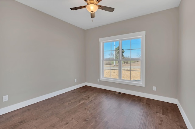 spare room featuring ceiling fan and dark hardwood / wood-style flooring