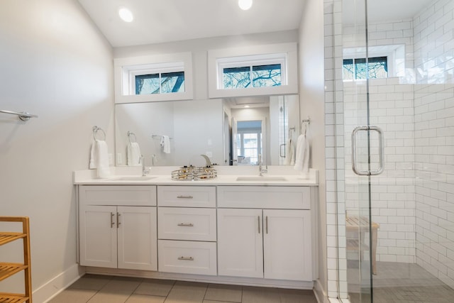 bathroom with vanity, a shower with shower door, and tile patterned flooring