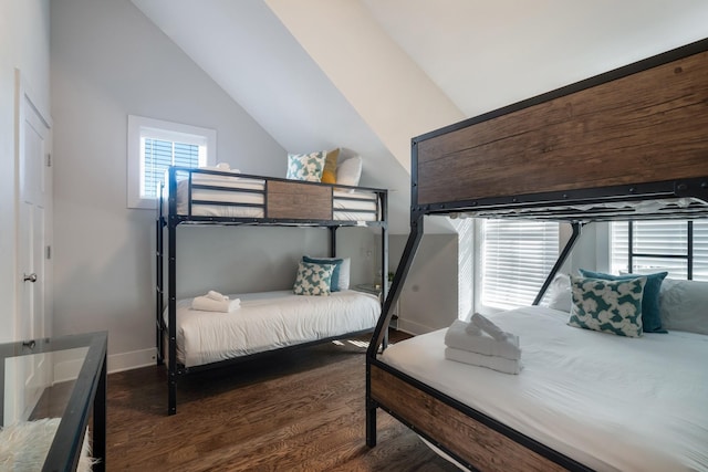 bedroom with dark hardwood / wood-style flooring and vaulted ceiling