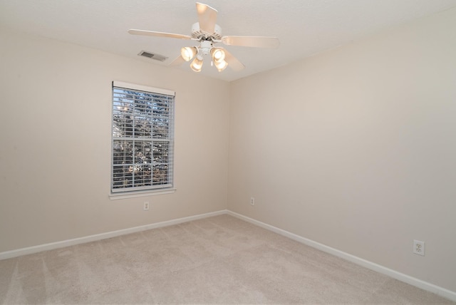 unfurnished room featuring light carpet and ceiling fan