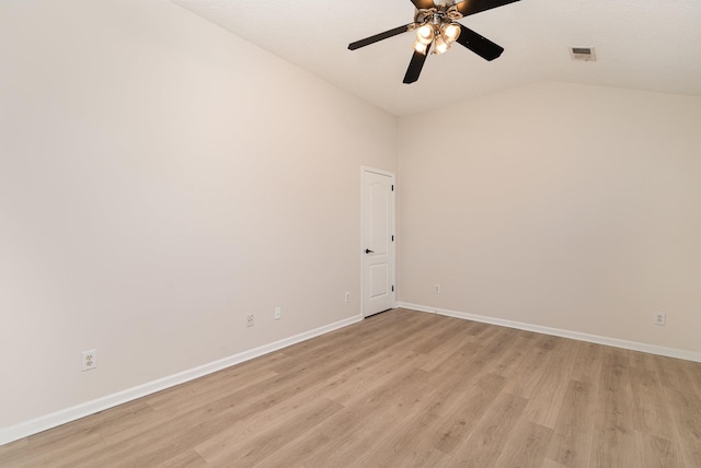 empty room featuring vaulted ceiling, ceiling fan, and light hardwood / wood-style floors