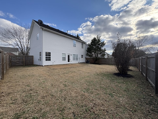 back of house with a lawn