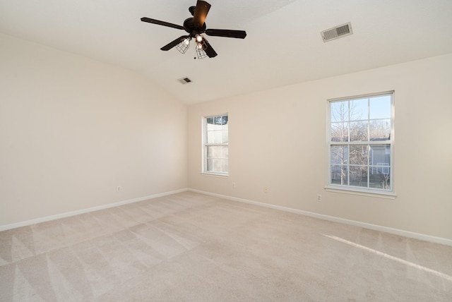 unfurnished room with lofted ceiling, light carpet, and ceiling fan