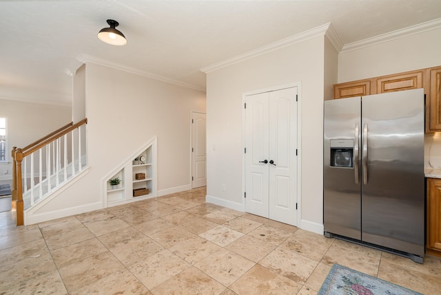 interior space featuring crown molding and built in shelves