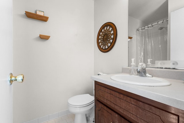 bathroom featuring vanity, toilet, and tile patterned flooring