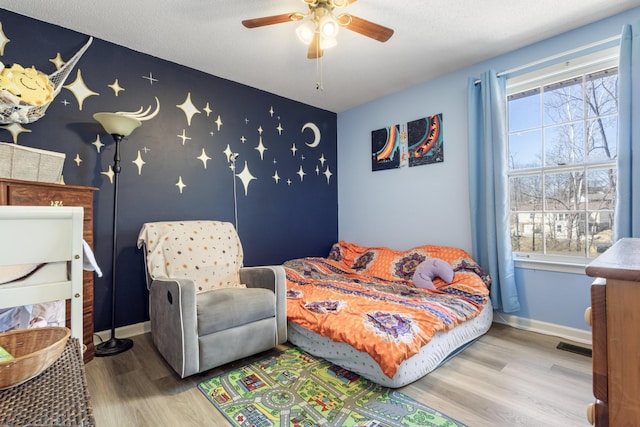 bedroom with hardwood / wood-style flooring and ceiling fan