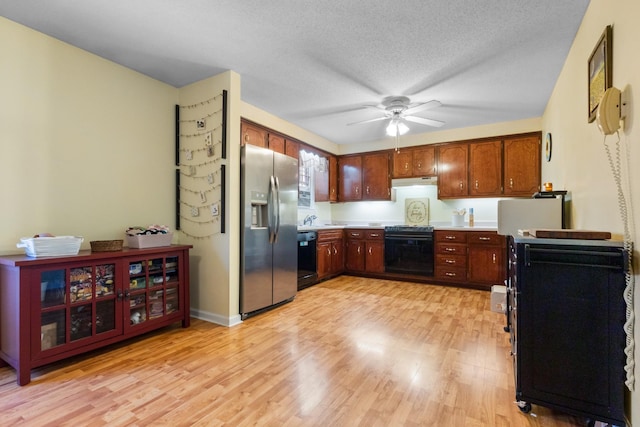 kitchen featuring dishwasher, range, stainless steel fridge with ice dispenser, a textured ceiling, and light hardwood / wood-style flooring