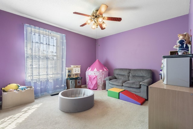 recreation room featuring ceiling fan and carpet