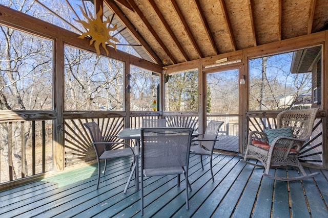 unfurnished sunroom with lofted ceiling