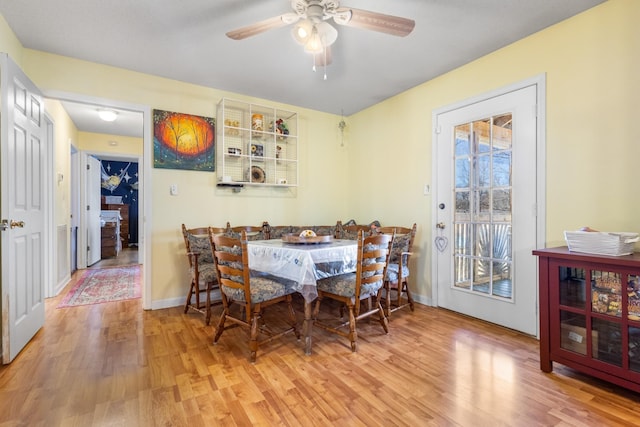 dining space with hardwood / wood-style flooring and ceiling fan