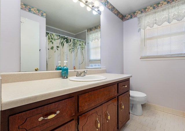 bathroom featuring vanity, tile patterned floors, and toilet