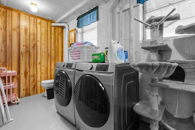 washroom featuring ornamental molding and independent washer and dryer