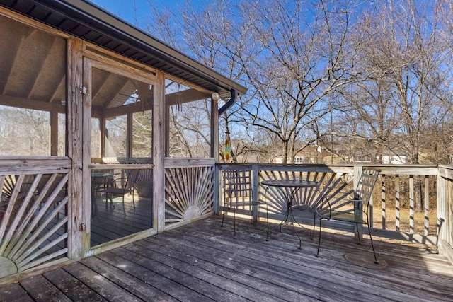 wooden deck featuring a sunroom