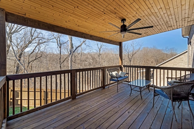 wooden terrace with ceiling fan and outdoor lounge area